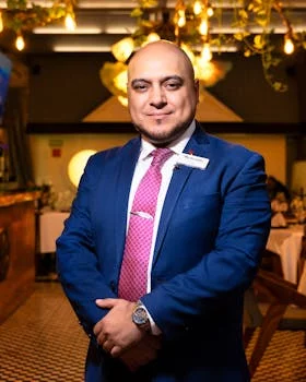 smiling restaurant manager in casual uniform