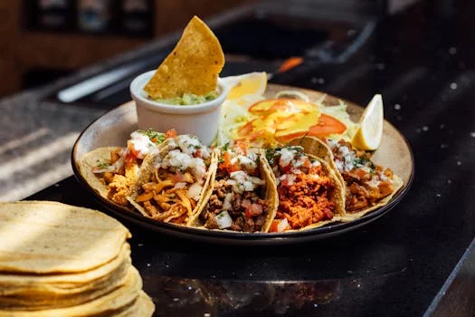 three crispy tacos with beef lettuce tomato